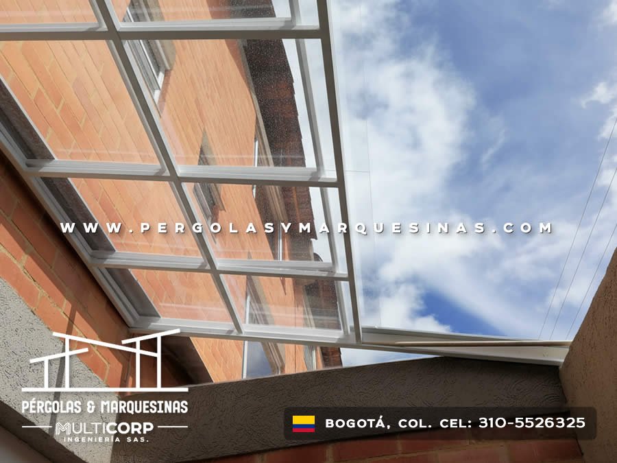 Estructura transparente de policarbonato con marco metálico en patio entre edificios en Bogotá, Colombia. Multicorp Ingeniería SAS.