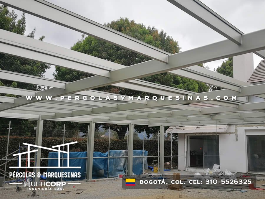 Estructura de pérgola metálica blanca sobre terraza junto a piscina en construcción en Bogotá, Colombia. Multicorp Ingeniería SAS.