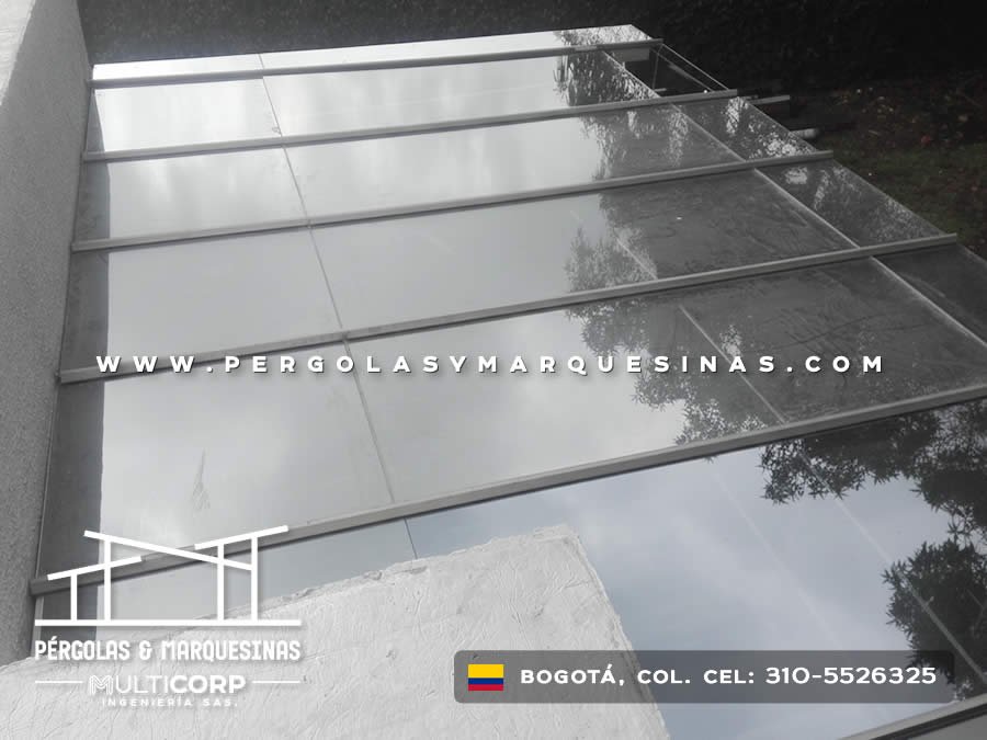 Cubierta traslúcida con perfiles metálicos sobre patio interior con muros blancos en construcción residencial en Bogotá, Colombia. Multicorp Ingeniería SAS.