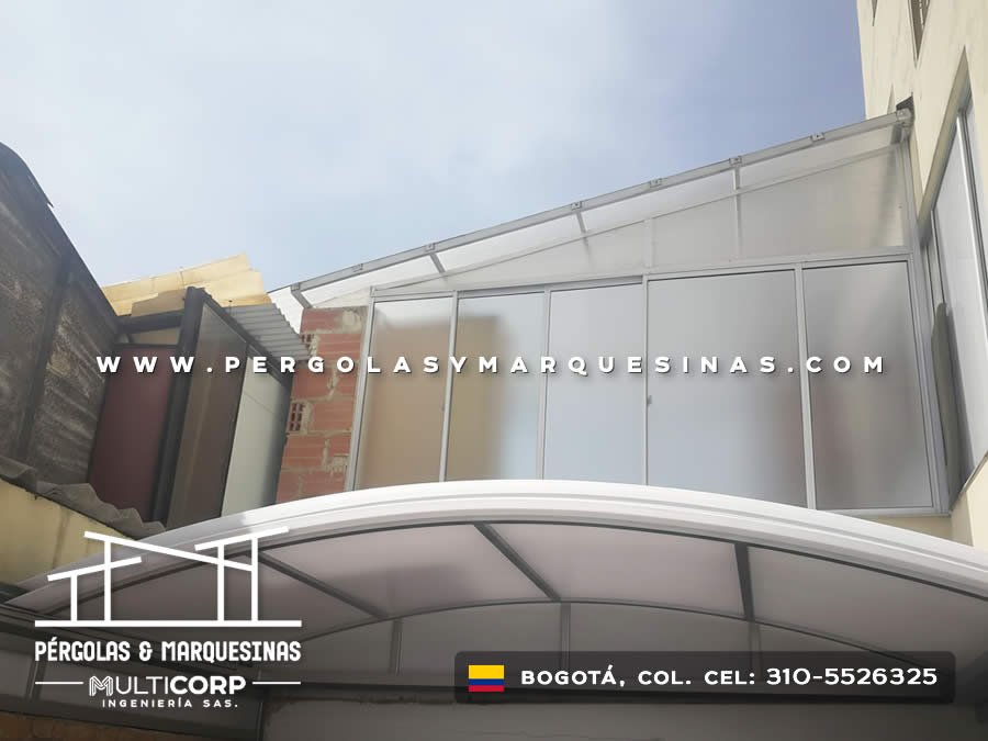 Cubierta curva de policarbonato con estructura metálica sobre terraza entre edificios urbanos en Bogotá, Colombia. Multicorp Ingeniería SAS. Cubierta curva de policarbonato con estructura metálica sobre terraza entre edificios urbanos en Bogotá, Colombia. Multicorp Ingeniería SAS.