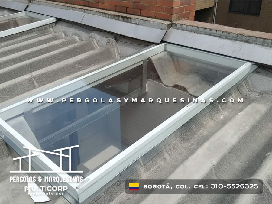 Claraboya de vidrio con marco metalico blanco sobre cubierta de teja en edificacion residencial en Bogotá, Colombia. Multicorp Ingeniería SAS.